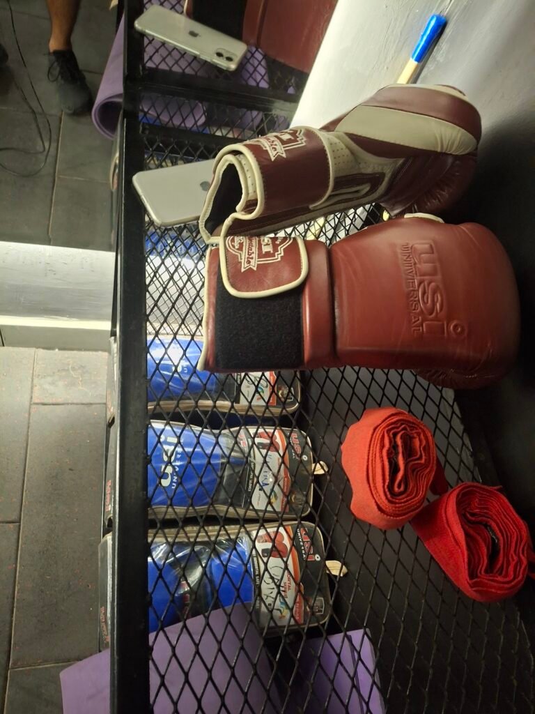 MMA training gloves and gear wall at BTF Gym New Chandigarh